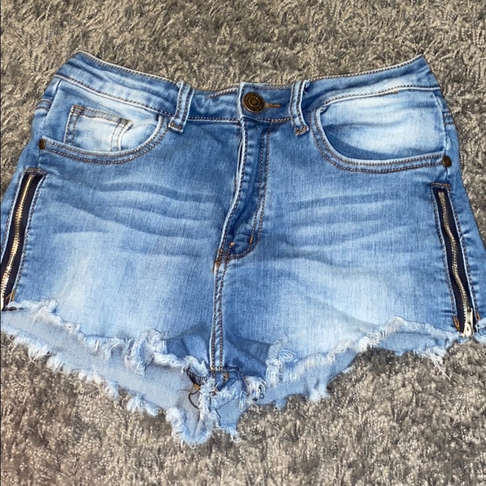 Blue jean shorts with zippers on the sides